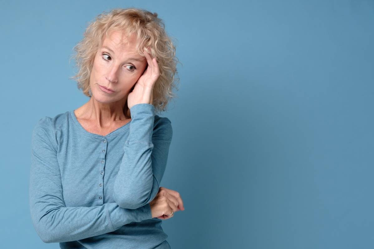 Middle aged lady looking away thinking of loneliness, getting older
