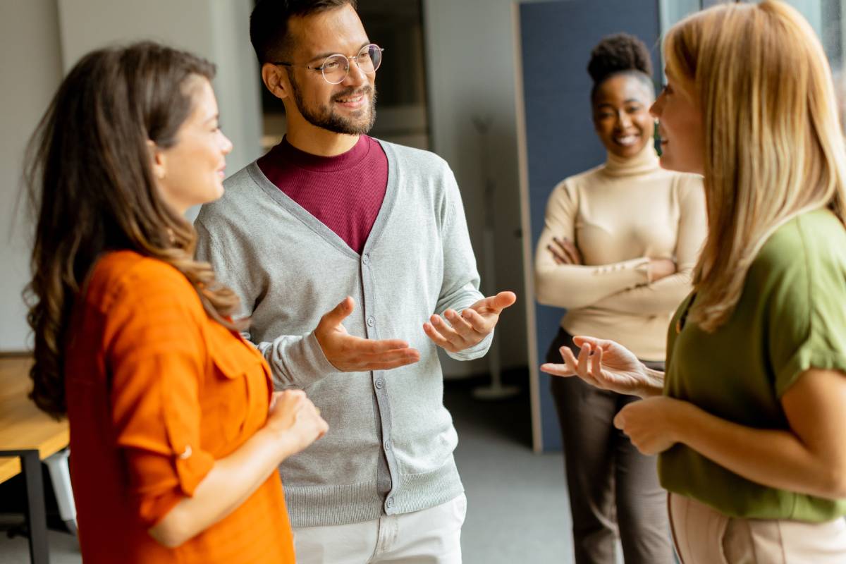 Cute Africam American woman with her young multiethnic startup team working in the modern office