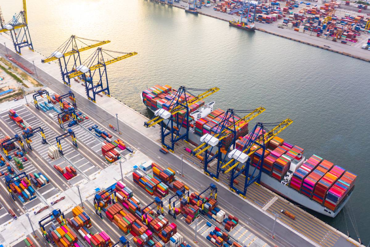 Container ship loading and unloading in deep sea port, Aerial top view of business logistic import and export freight transportation by container ship in open sea.